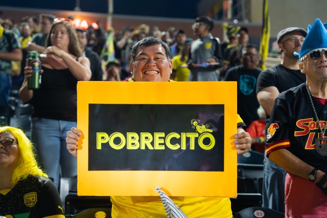 A NM United fan old up a sign that reads 