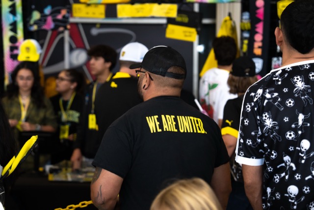 A NM United fan wears a T-Shirt with the words 