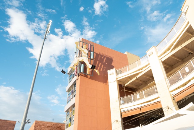 Exterior of Isotopes Park with a partly cloudy blue sky.