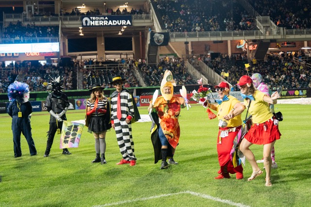 A halftime costume contest shows many participants in their unique attire.