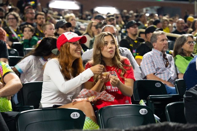 Two UNM students eat concessions at the NM United game.