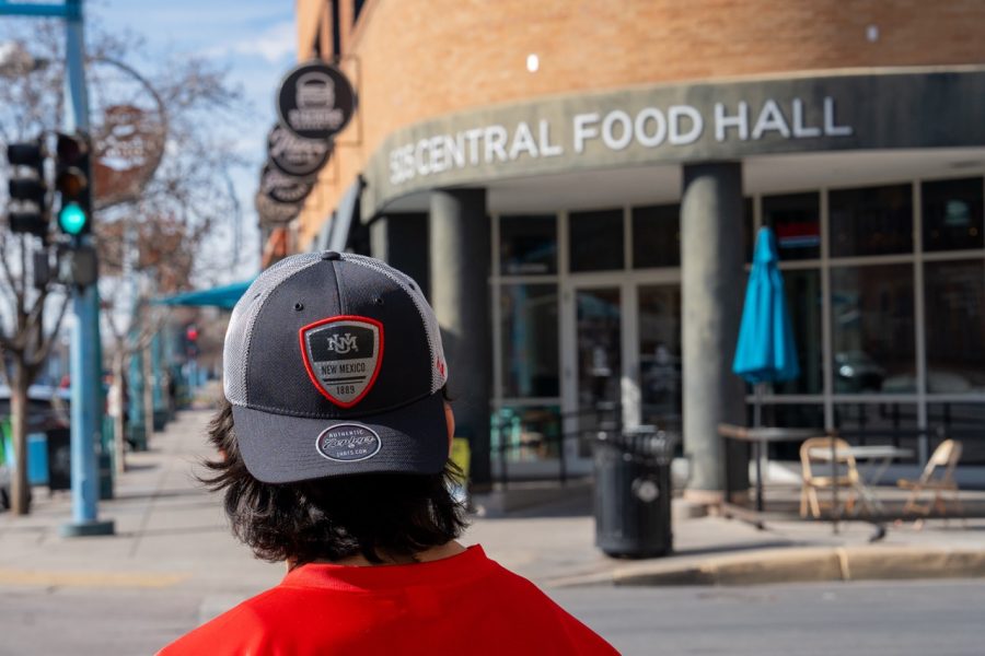 The backwards UNM cap of a student is shown outside of 505 Central Food Hall.
