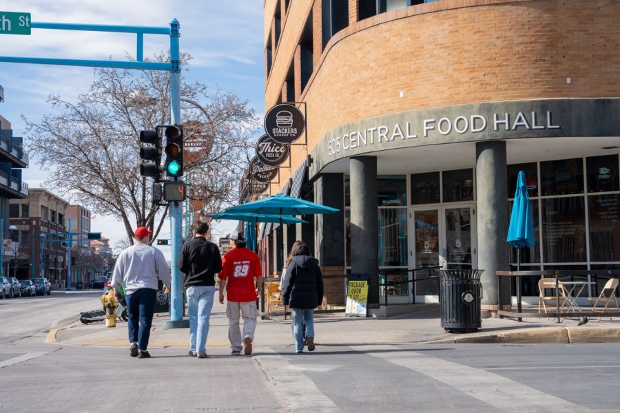 Five UNM Students walk towards 505 Central Food Hall in Downtown Albuquerque.