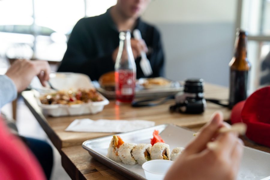 A close up shot of sushi and Chinese food.