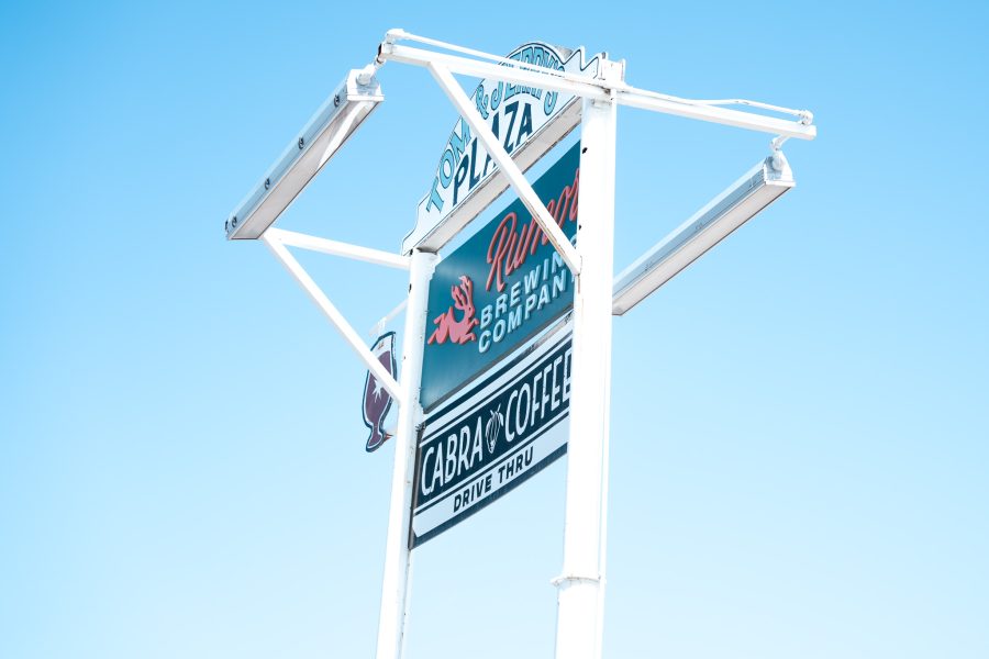 A sign against a clear blue sky reads 