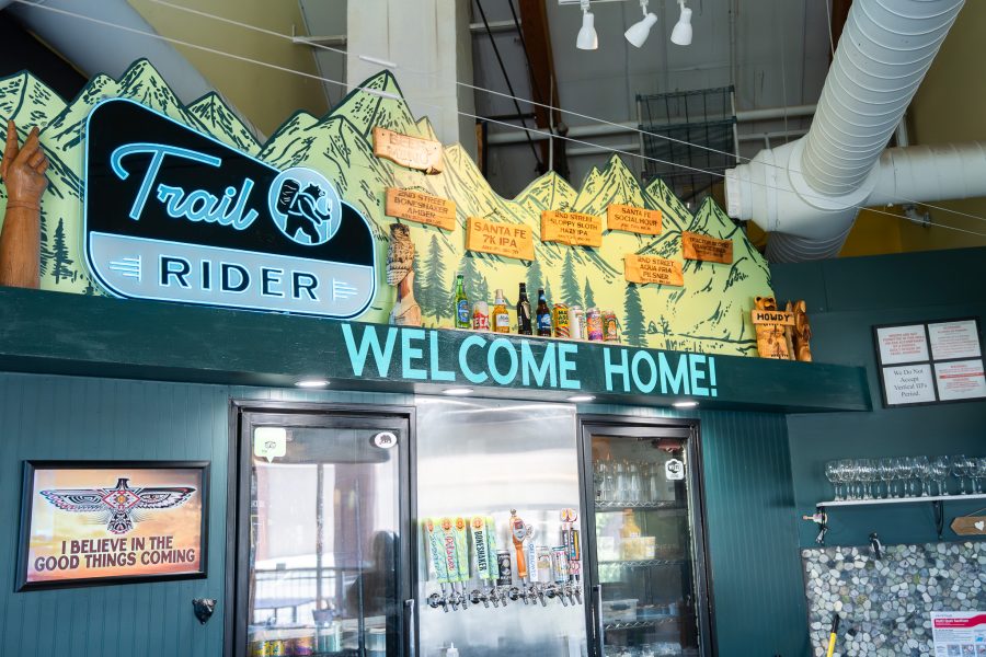 The interior of Trail Rider Pizza with a sign that says 