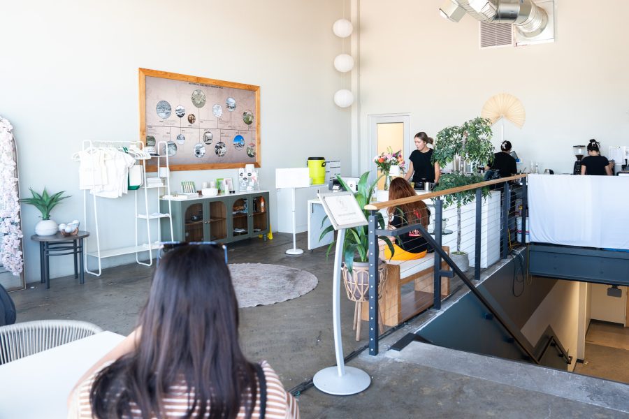 Interior of Homebody Matcha shows merchandise, plants and wall art.